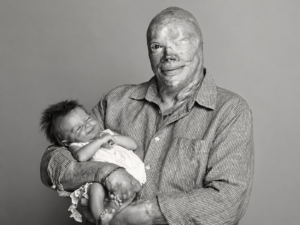 Joe Kinan con su hija en brazos, años después de sobrevivir al incendio de The Station.